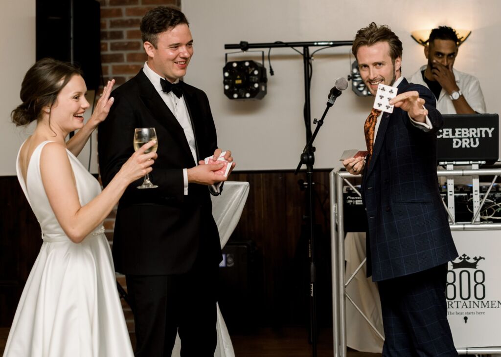 6ED5F1A3-DD97-4271-89DD-8F7AABB8982B_1_102_a Wedding magician - Card Reveal at Mini Show in wedding in Canada. Bride and Groom involved