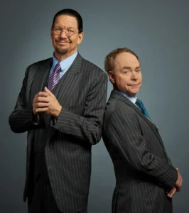 Famous magicians - Penn & Teller performing on stage, a world-famous magician duo known for comedy magic and illusion shows.