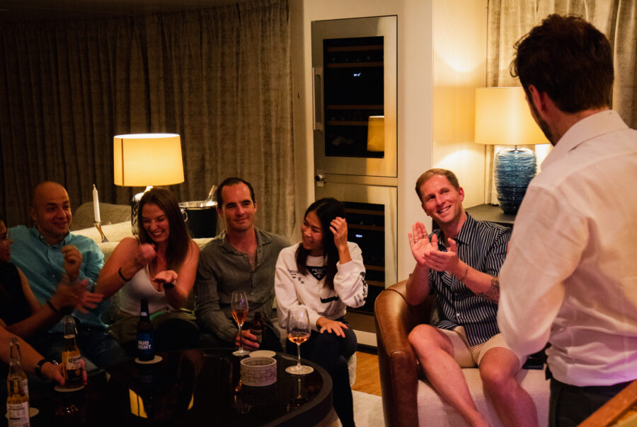 Yacht guests enjoying Chris Dodd's magic show, Overboard